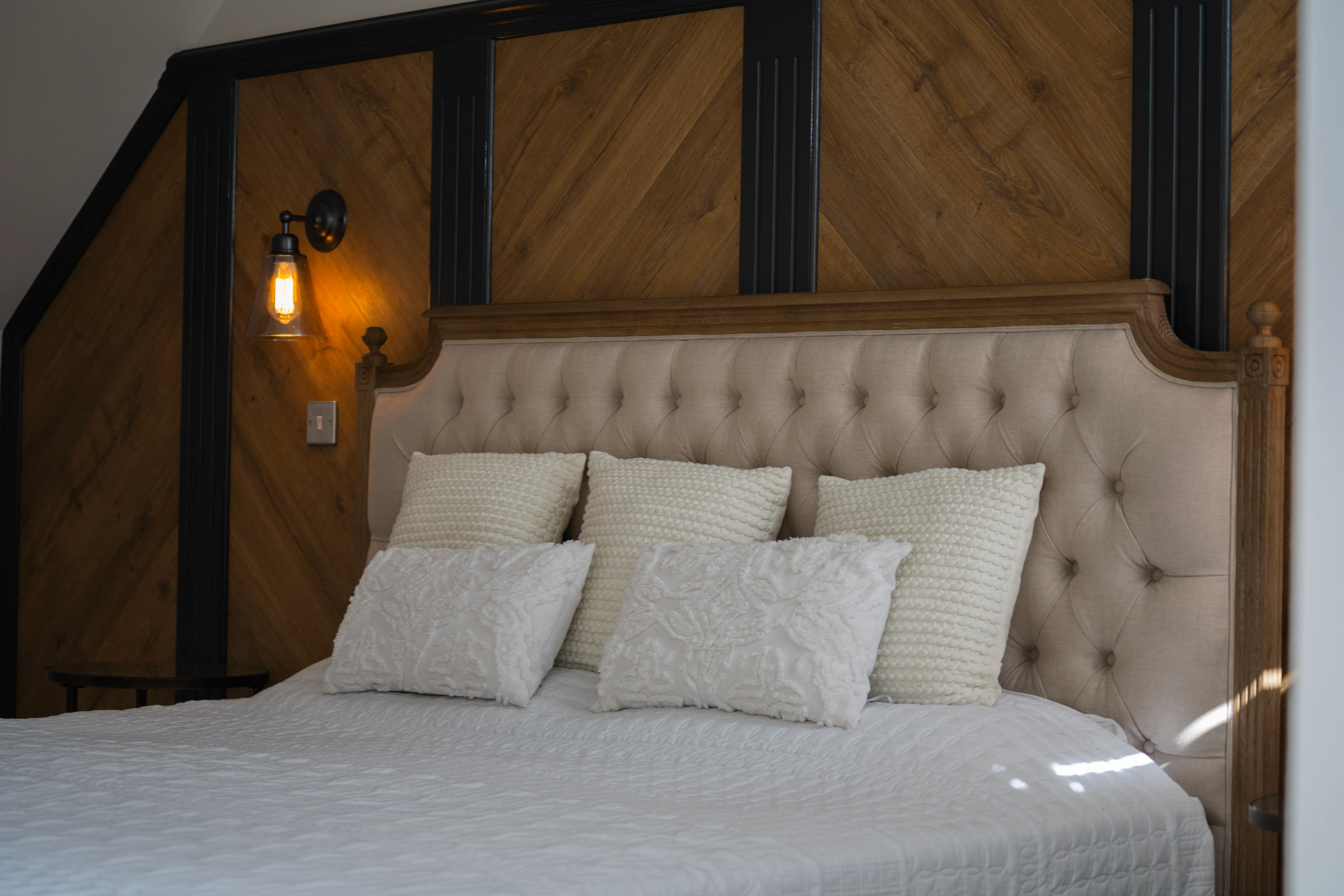 a bed with four pillows on top of it